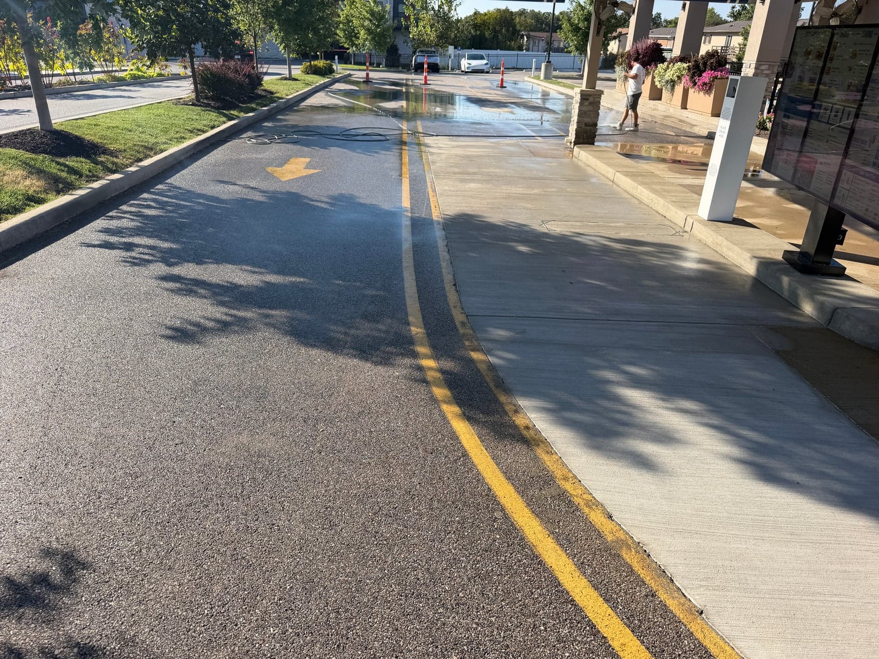 ATC washing concrete beside a drive-through